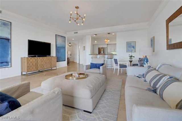 living room featuring crown molding and a notable chandelier