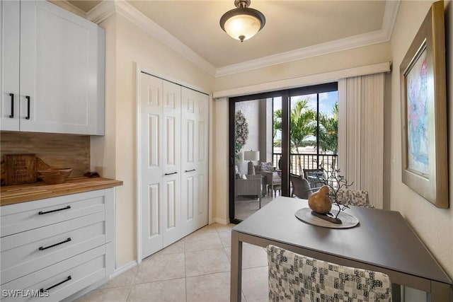 interior space featuring ornamental molding and light tile patterned floors