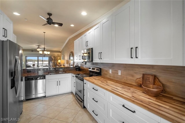 kitchen with white cabinetry, appliances with stainless steel finishes, sink, and wooden counters