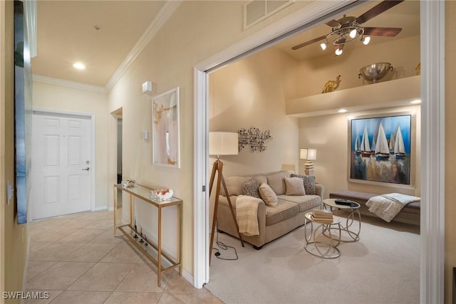 tiled living room featuring crown molding and ceiling fan