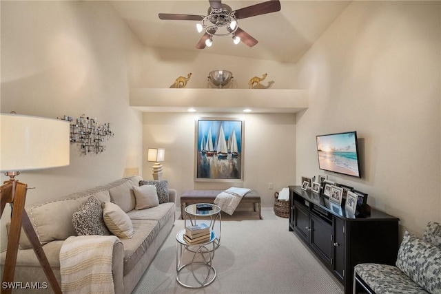 carpeted living room featuring vaulted ceiling and ceiling fan