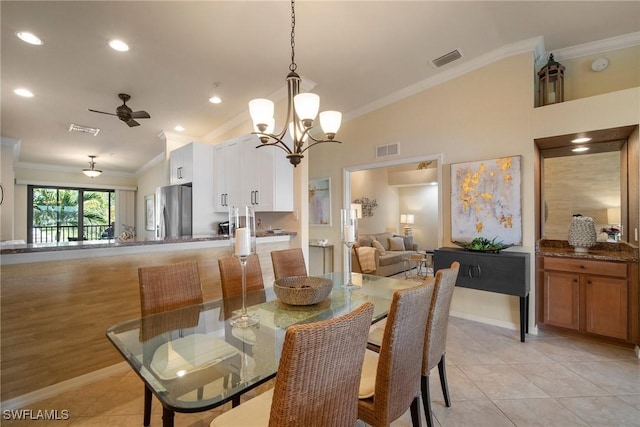 tiled dining space with crown molding, ceiling fan, and a high ceiling