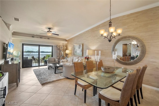 tiled dining space featuring crown molding, vaulted ceiling, and ceiling fan with notable chandelier