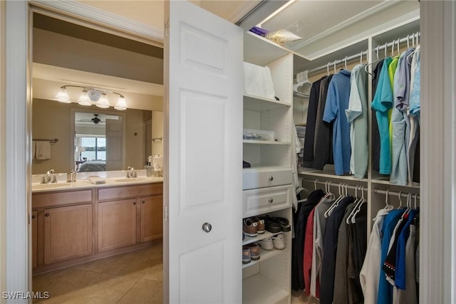 walk in closet with sink and light tile patterned floors