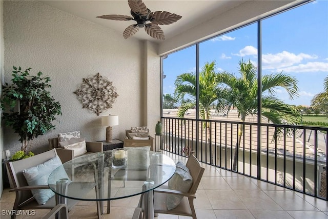 sunroom / solarium featuring ceiling fan