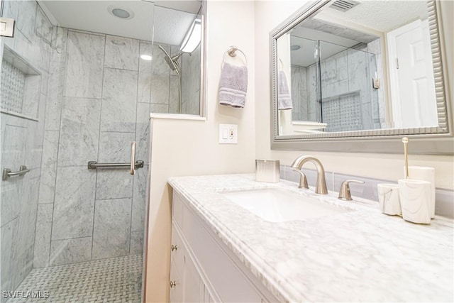 bathroom featuring vanity and tiled shower