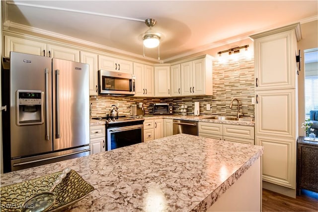 kitchen with sink, dark hardwood / wood-style floors, stainless steel appliances, light stone countertops, and backsplash