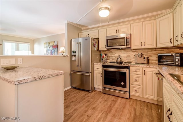 kitchen featuring crown molding, light hardwood / wood-style flooring, appliances with stainless steel finishes, backsplash, and cream cabinetry