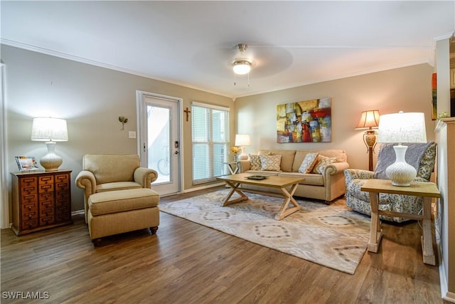 living room with hardwood / wood-style flooring, ceiling fan, and crown molding