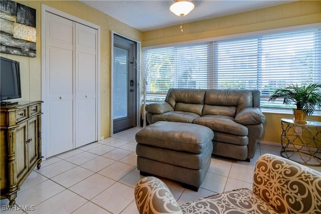 living room with light tile patterned flooring and a wealth of natural light