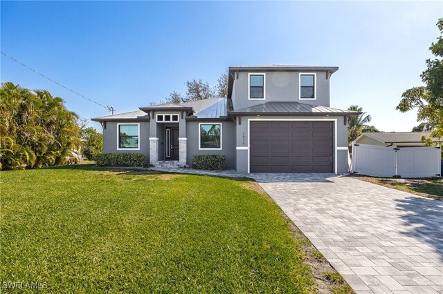 view of front of house featuring a garage and a front yard