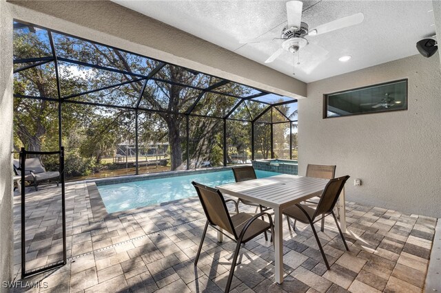 view of swimming pool with a patio, a lanai, and ceiling fan