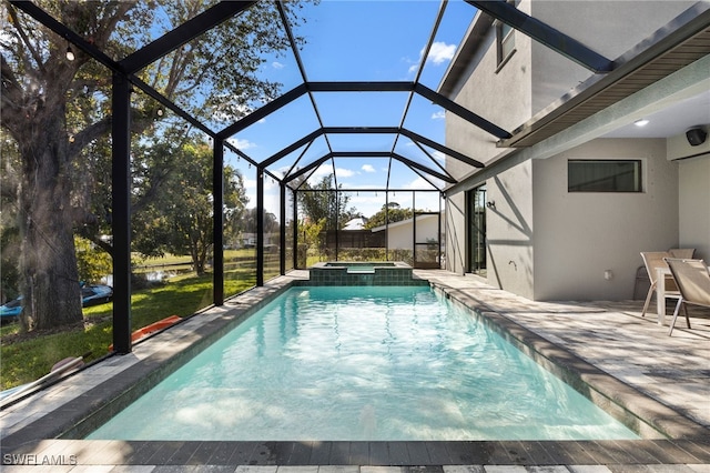 view of swimming pool featuring an in ground hot tub, a lanai, and a patio area