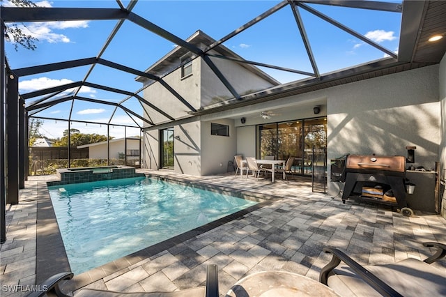 view of pool with an in ground hot tub, ceiling fan, glass enclosure, and a patio