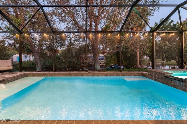 view of swimming pool featuring a lanai