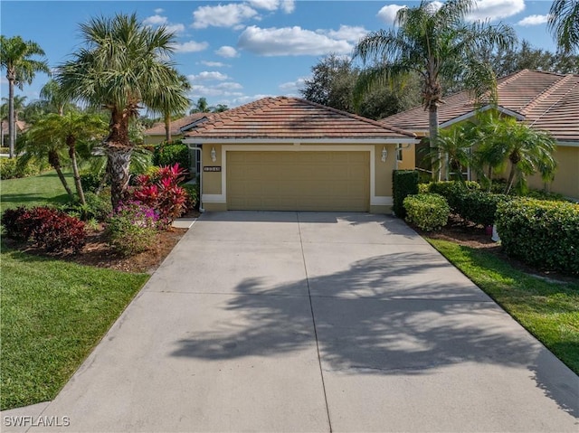 view of front of property featuring a garage and a front yard