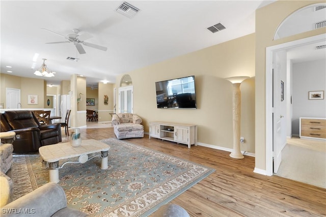 living room with ceiling fan and light wood-type flooring