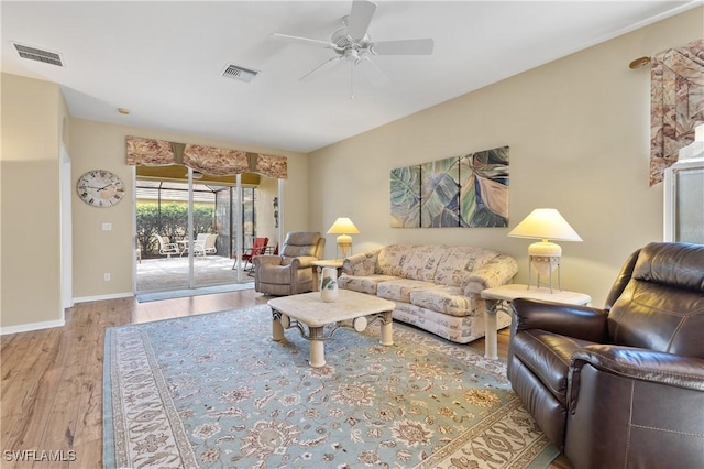 living room featuring ceiling fan and light hardwood / wood-style flooring