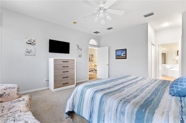 carpeted bedroom with ceiling fan and ensuite bathroom