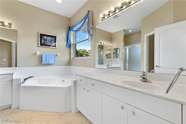 bathroom featuring plus walk in shower, tile patterned floors, and vanity