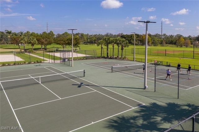 view of sport court featuring a lawn