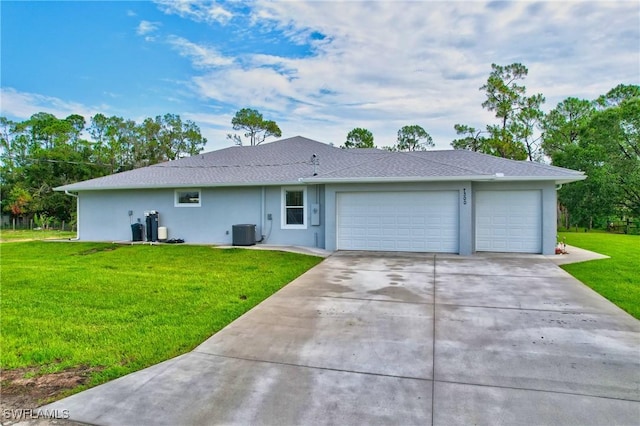 view of front of house featuring central AC, a garage, and a front yard