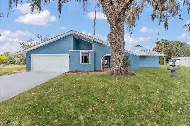 ranch-style home featuring a garage and a front lawn