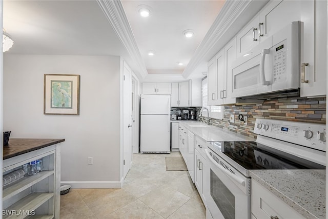 kitchen featuring sink, white appliances, crown molding, white cabinetry, and a tray ceiling