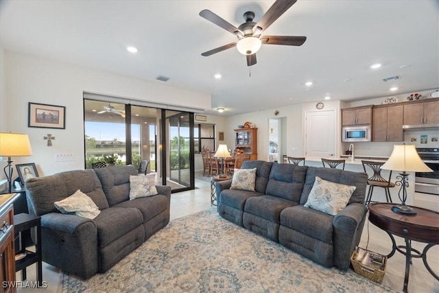living room with sink and ceiling fan