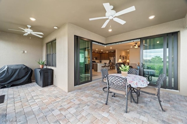 view of patio with ceiling fan and a grill