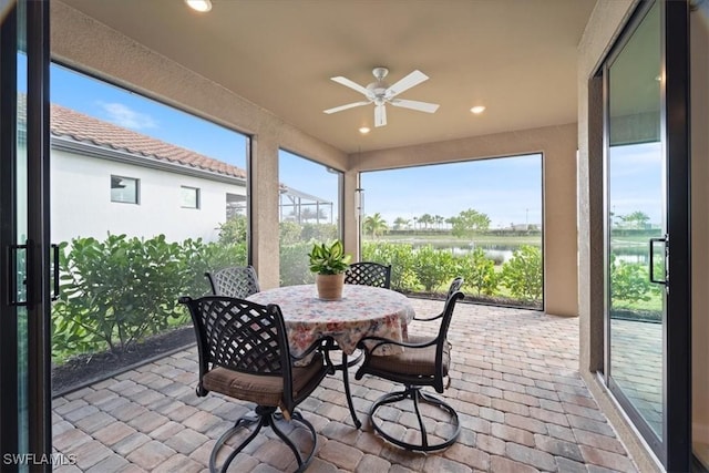 sunroom featuring ceiling fan