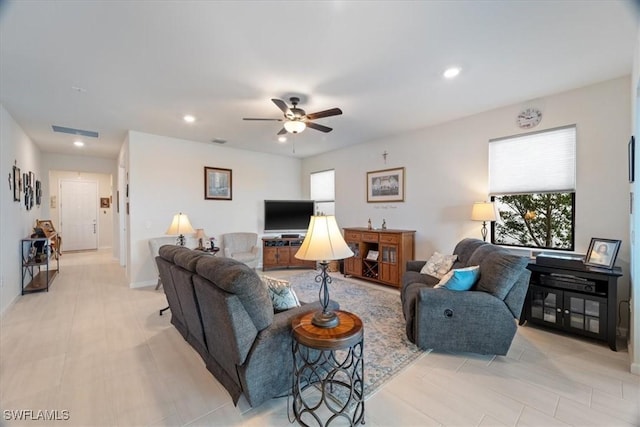 tiled living room featuring ceiling fan