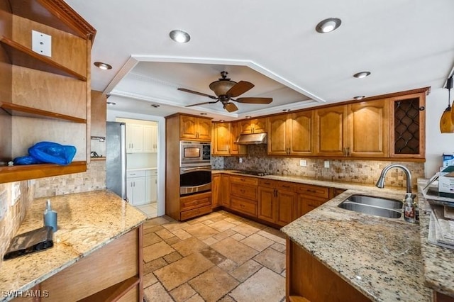 1400 Blue Point Ave Unit 207, Naples, FL 34102 - kitchen featuring appliances with stainless steel finishes, open shelves, a sink, a tray ceiling, and stone tile floors