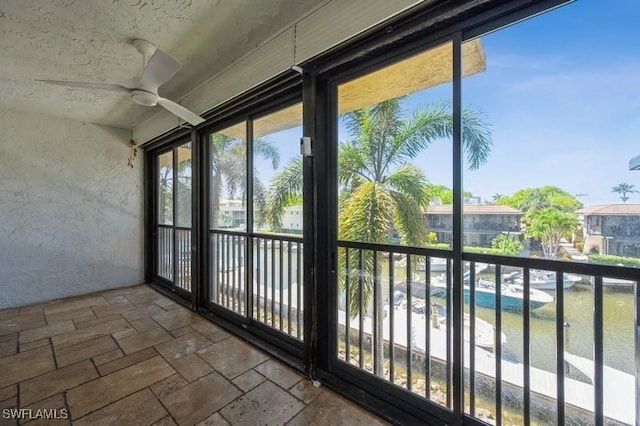 1400 Blue Point Ave Unit 207, Naples, FL 34102 - unfurnished sunroom featuring stone tile flooring and a textured wall