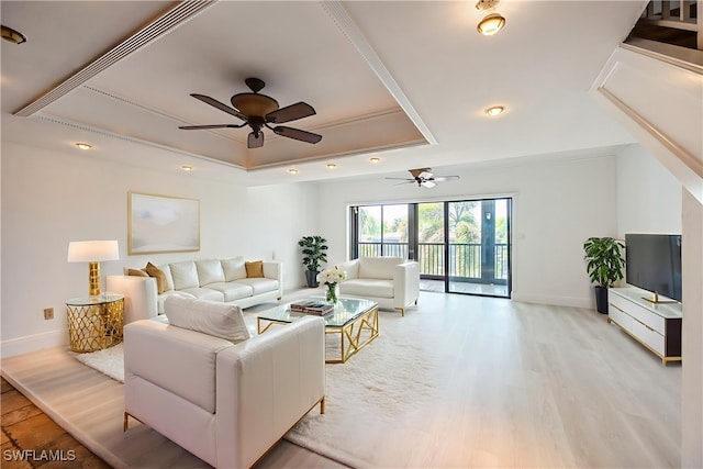 1400 Blue Point Ave Unit 207, Naples, FL 34102 - living room featuring a tray ceiling, a ceiling fan, baseboards, and light wood-style floors