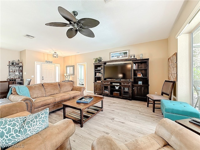 living room with ceiling fan and light wood-type flooring