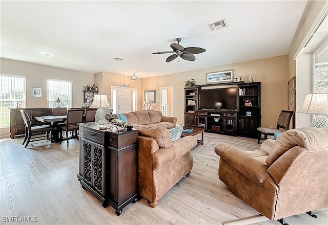 living room featuring ceiling fan and light hardwood / wood-style flooring