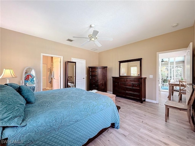 bedroom with ceiling fan, lofted ceiling, and light wood-type flooring