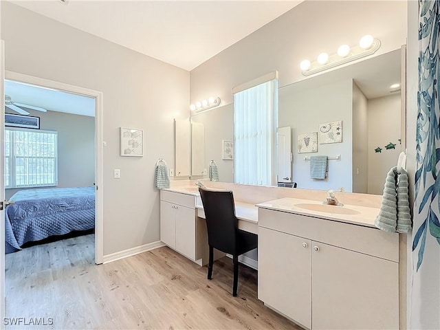 bathroom with hardwood / wood-style flooring, vanity, and ceiling fan