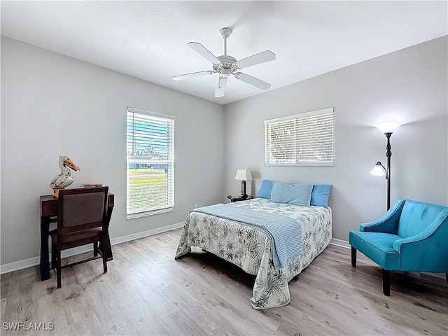 bedroom with ceiling fan and light hardwood / wood-style floors