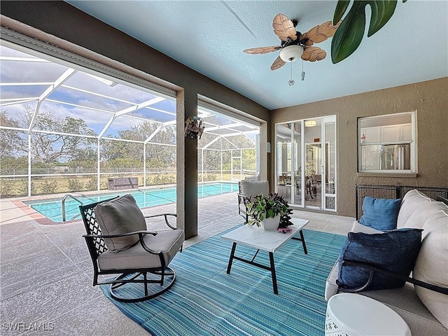 view of patio with an outdoor living space, a lanai, and ceiling fan