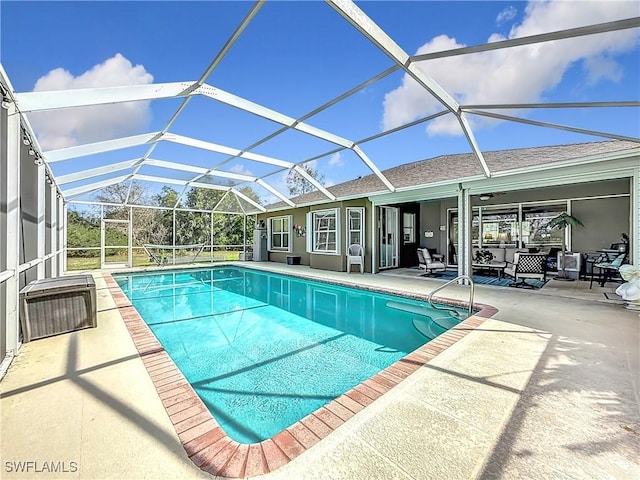 view of pool featuring a patio area and glass enclosure