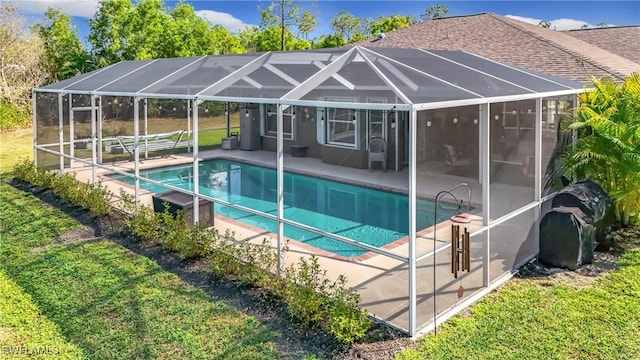 view of swimming pool with a patio and glass enclosure