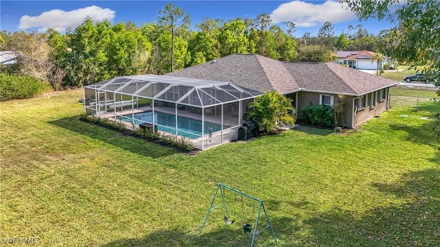 view of swimming pool with a lanai and a lawn