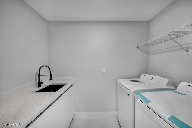 laundry room featuring sink and washing machine and clothes dryer