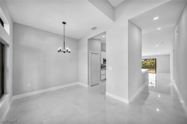 hallway featuring a chandelier