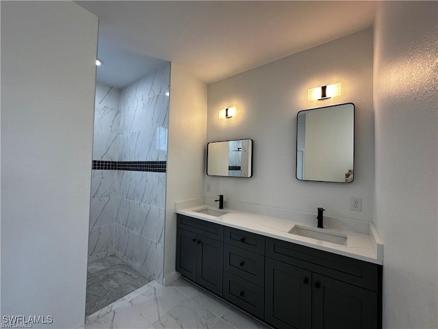 bathroom with vanity and a tile shower