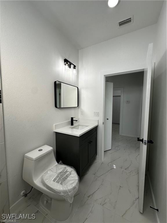 bathroom with vanity and toilet