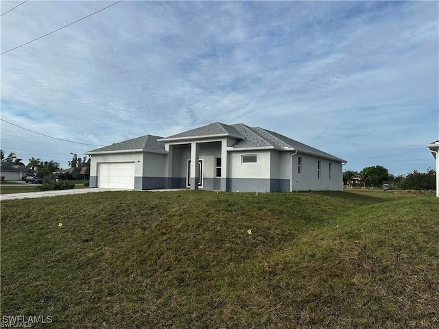 view of front facade with a garage and a front lawn