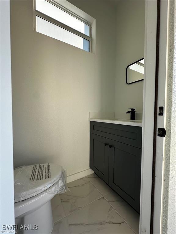 bathroom featuring vanity and toilet